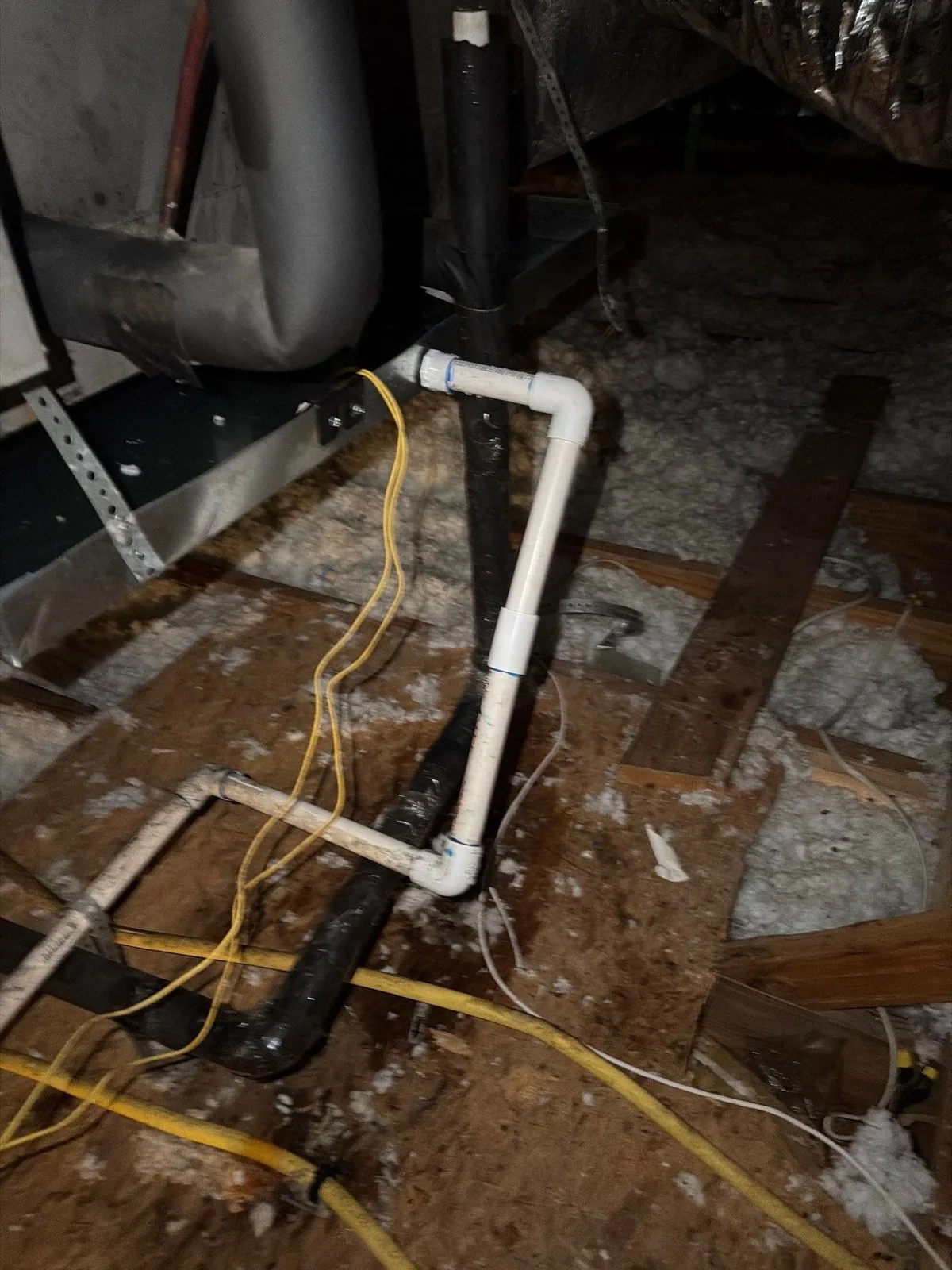 Condensate drain line and trap running off an air handler in the attic