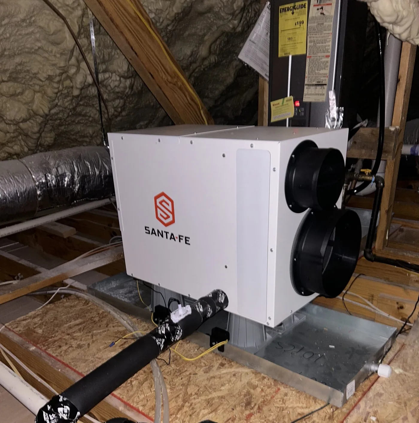 Whole-house dehumidifier installed in an attic